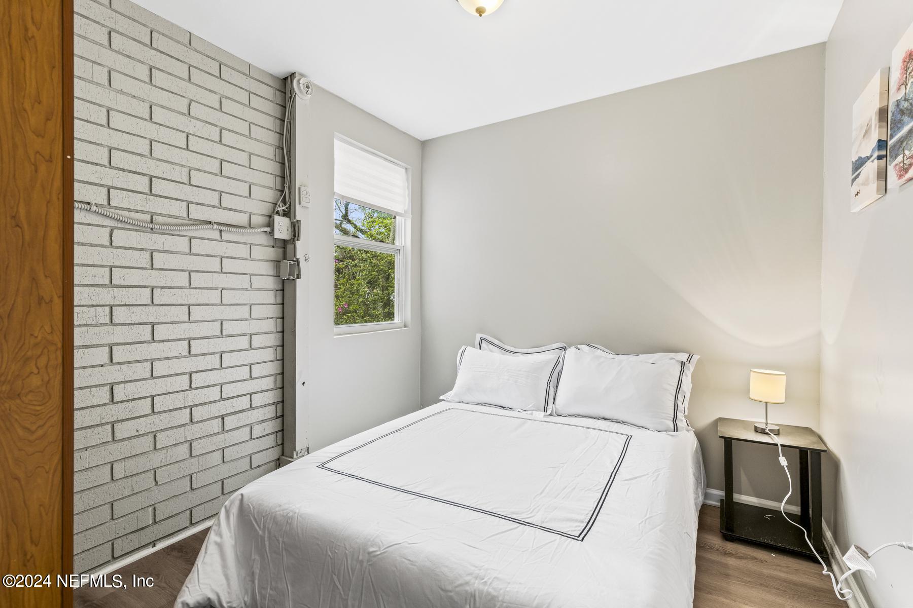 7142 Richardson Road Jacksonville, FL 32209 - Photo 4 of 10 a bedroom with a bed and a window