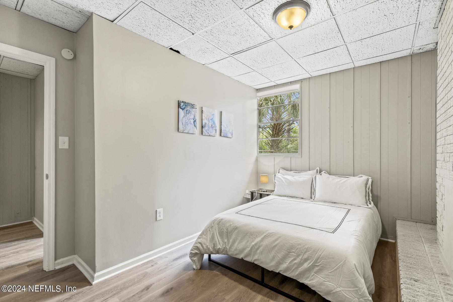 7142 Richardson Road Jacksonville, FL 32209 - Photo 5 of 10 a bedroom with a bed and a window