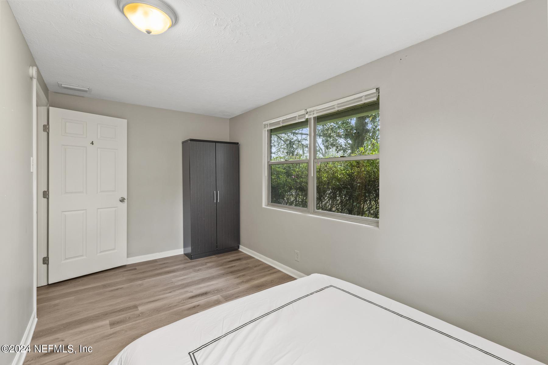 7142 Richardson Road Jacksonville, FL 32209 - Photo 7 of 10 a bedroom with a bed and a window
