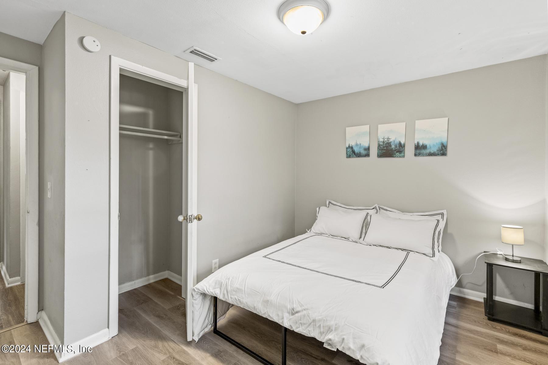 7142 Richardson Road Jacksonville, FL 32209 - Photo 9 of 10 a bedroom with a bed and a painting on the wall