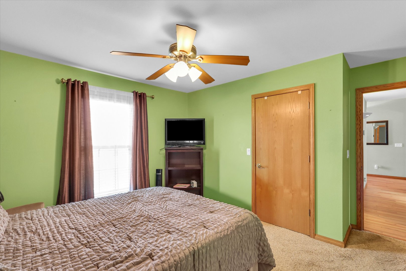 3110 Ridge Park Road Urbana, IL 61802 - Photo 17 of 26 a bedroom with a bed and a flat tv screen on dresser