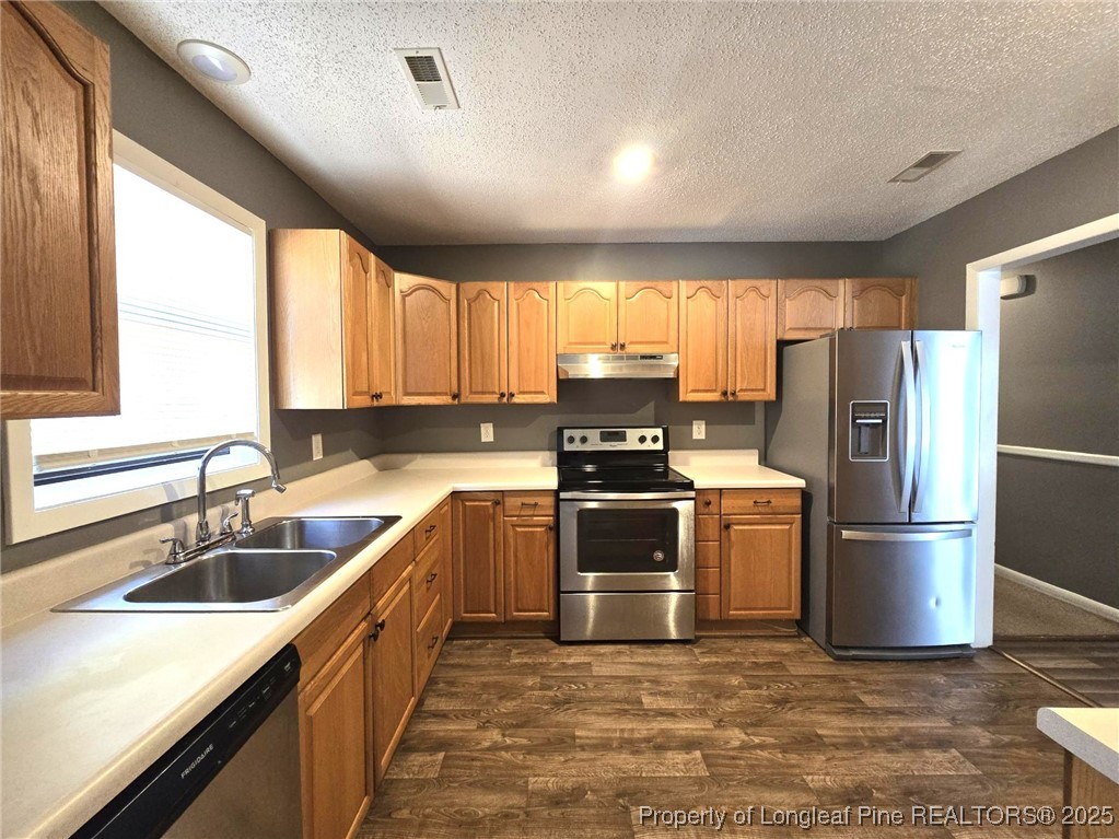 1540 Graystone Road Fayetteville, NC 28311 - Photo 8 of 19 a kitchen with refrigerator a sink and a microwave