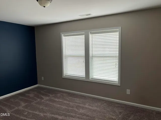 a bathroom with a double vanity sink a mirror and shower