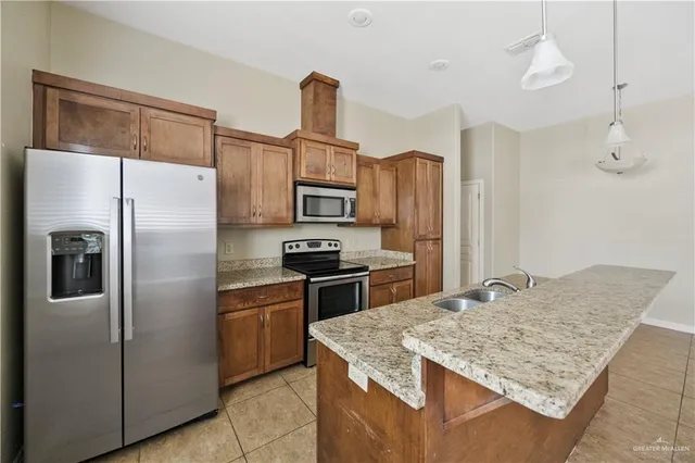 a kitchen with stainless steel appliances a refrigerator sink and microwave