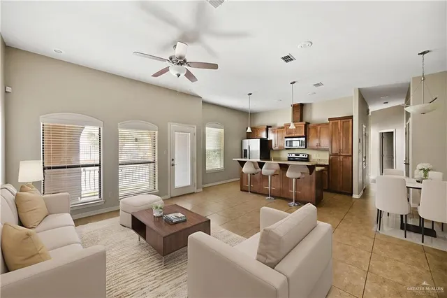 a large white kitchen with a large window cabinets and stainless steel appliances