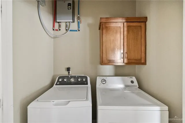 a spacious bedroom with a large bed and a chandelier