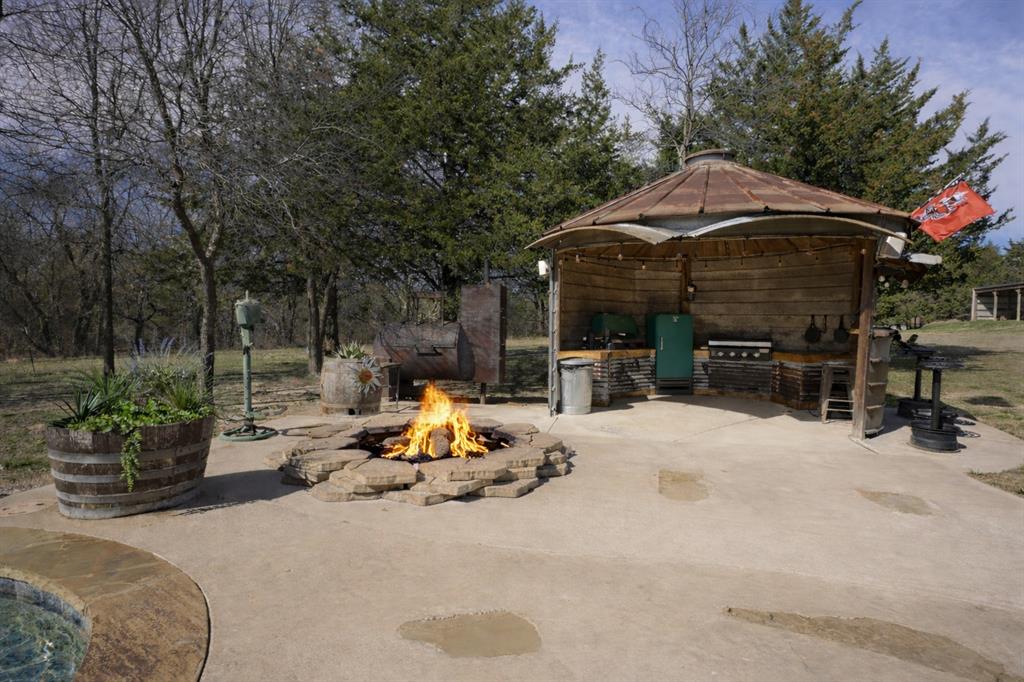 1011 Red Road Howe, TX 75459 - Photo 19 of 39 a view of a patio with table and chairs under an umbrella