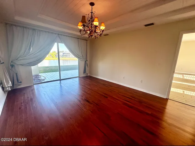 a view of room with window and wooden floor