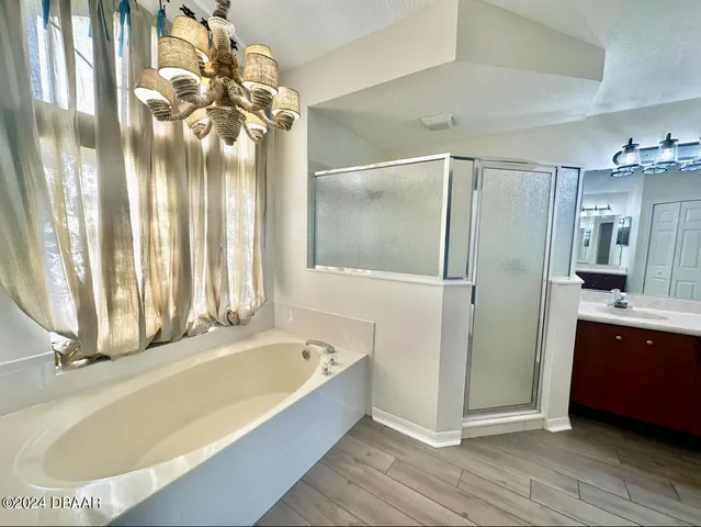 a bathroom with a tub and a shower