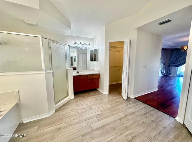 a view of room with wooden floor and cabinet