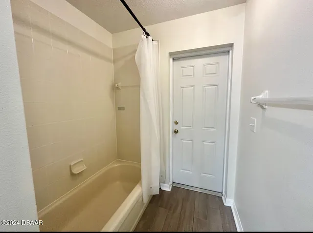 a bathroom with a shower and a bath tub