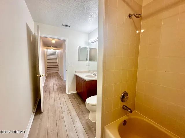 a bathroom with a tub a sink and mirror