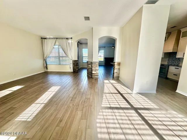 a view of a room with wooden floor and windows