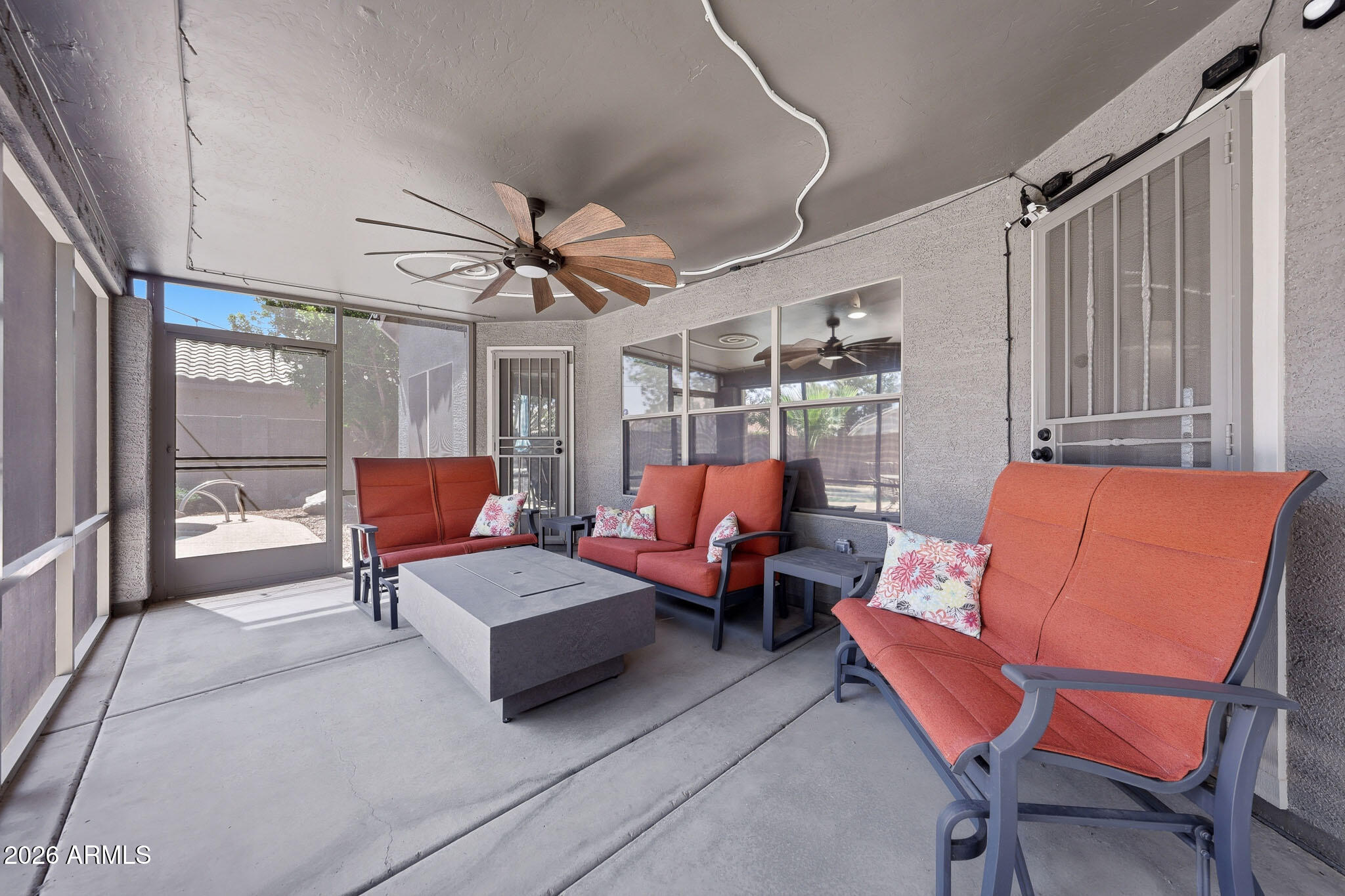 2153 East Kempton Road Chandler, AZ 85225 - Photo 23 of 50 a living room with furniture a ceiling fan and a window