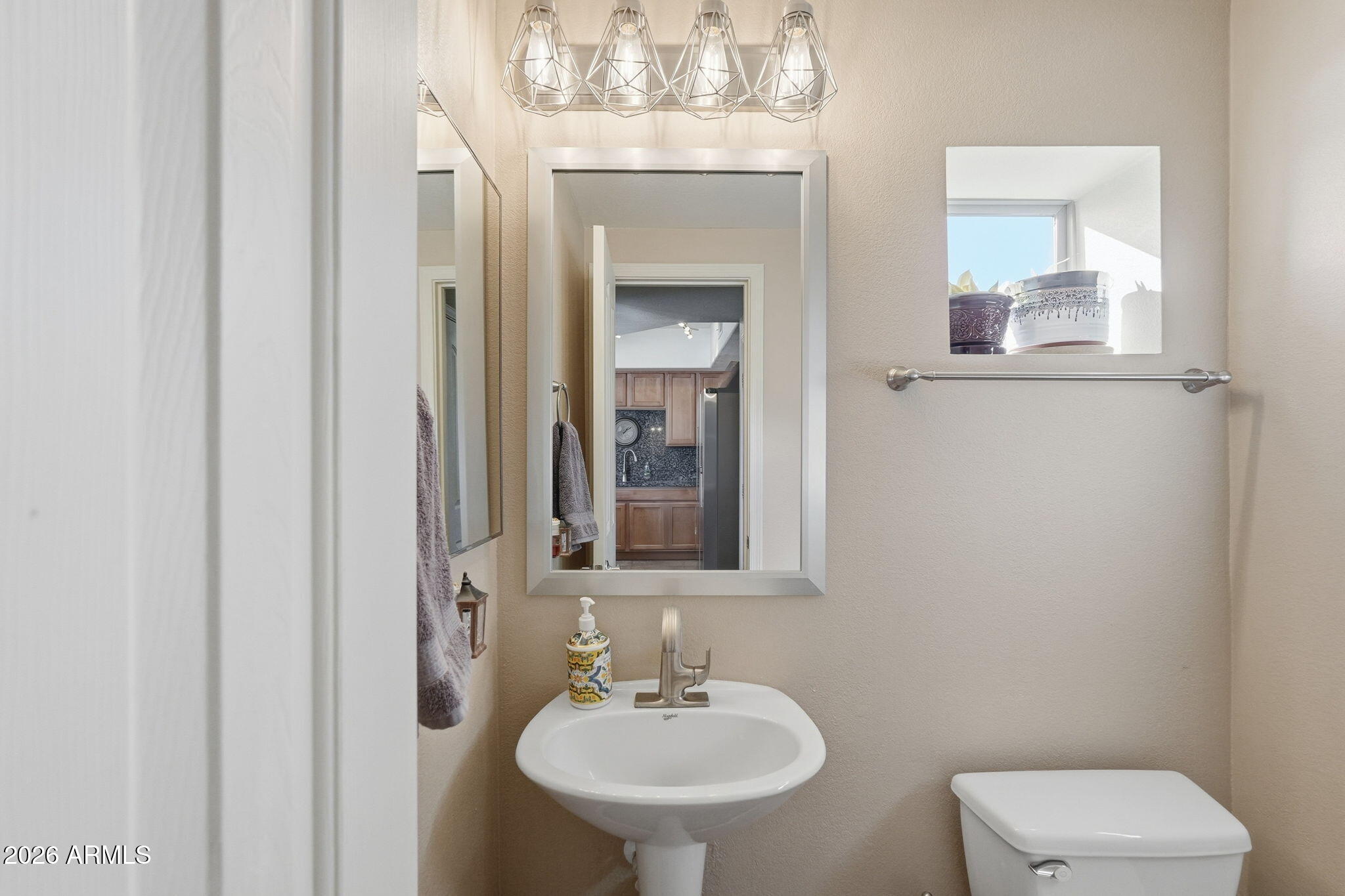 280 South Evergreen Road, Unit 1320 Tempe, AZ 85288 - Photo 12 of 14 a bathroom with a toilet a sink and mirror