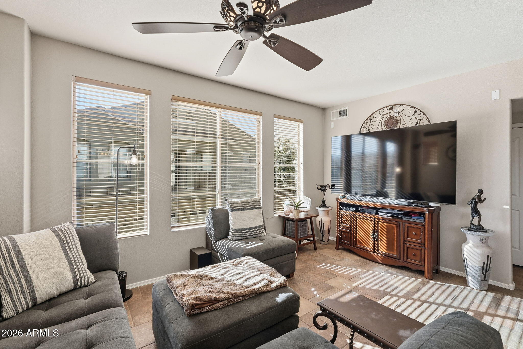 280 South Evergreen Road, Unit 1320 Tempe, AZ 85288 - Photo 2 of 14 a living room with furniture a large window and a flat screen tv