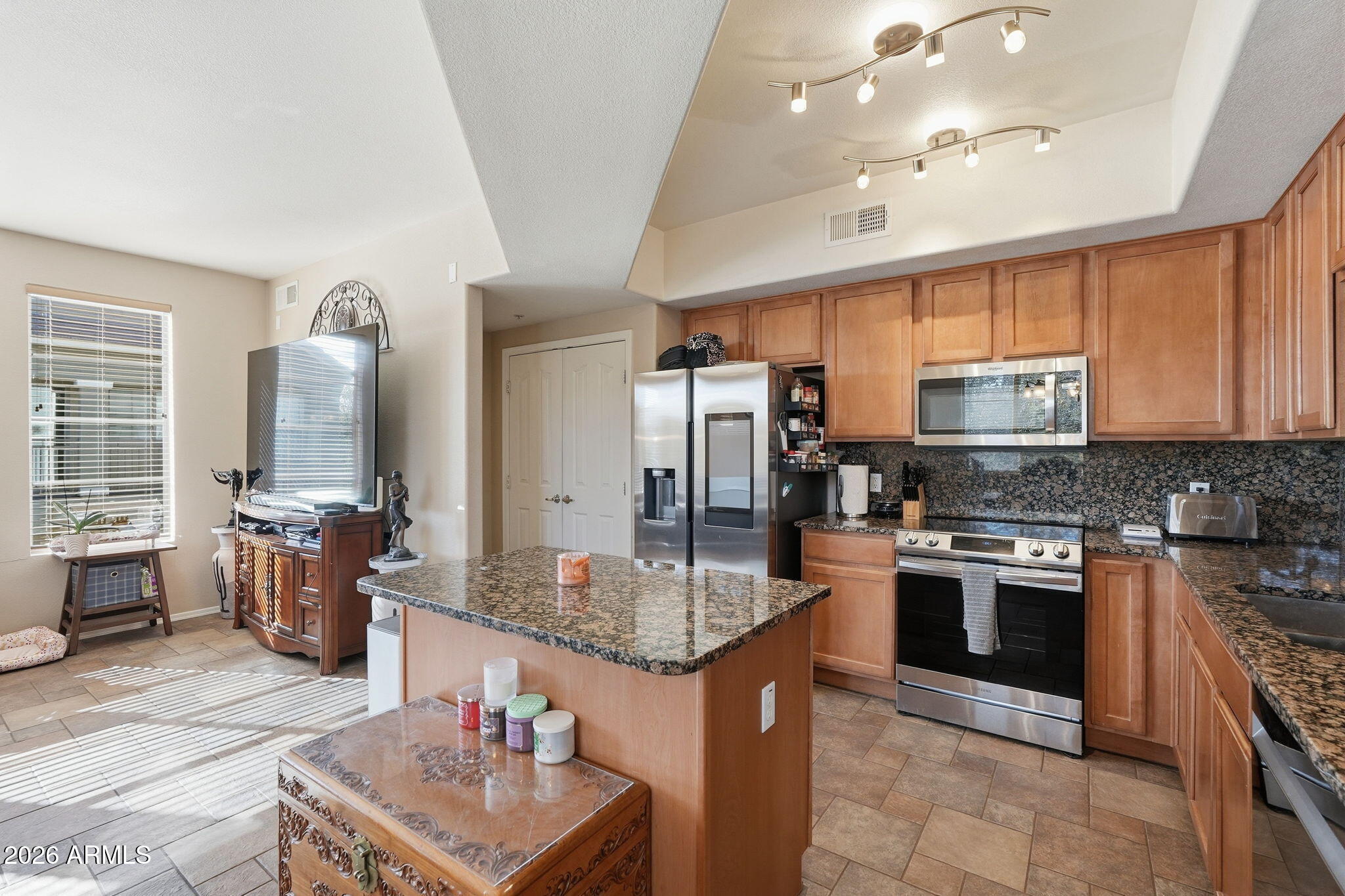 280 South Evergreen Road, Unit 1320 Tempe, AZ 85288 - Photo 5 of 14 a kitchen with stainless steel appliances granite countertop a sink stove and refrigerator