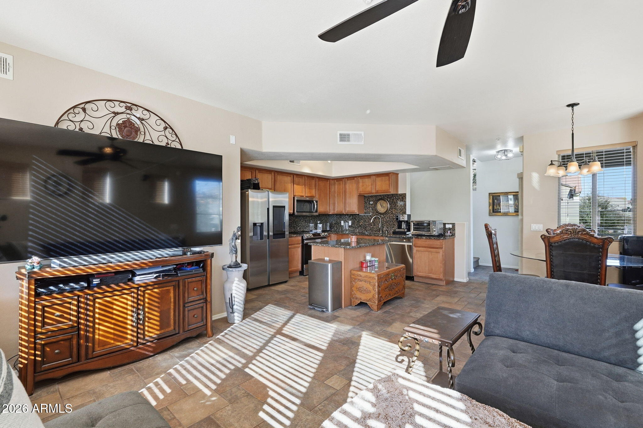 280 South Evergreen Road, Unit 1320 Tempe, AZ 85288 - Photo 6 of 14 a living room with furniture and a flat screen tv