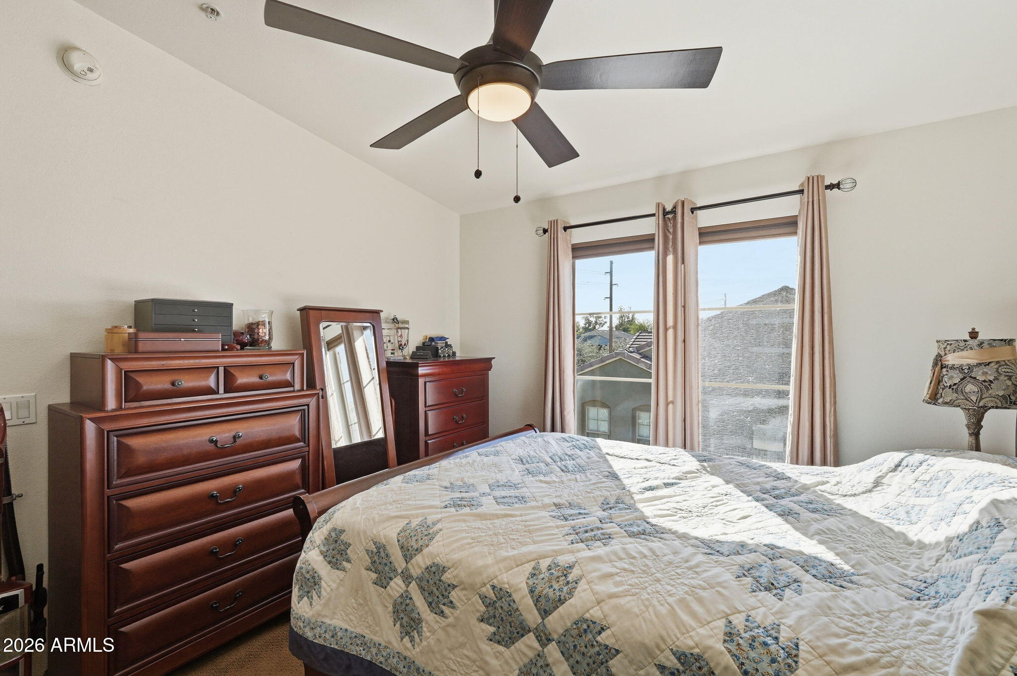 280 South Evergreen Road, Unit 1320 Tempe, AZ 85288 - Photo 8 of 14 a bedroom with a bed and a chandelier