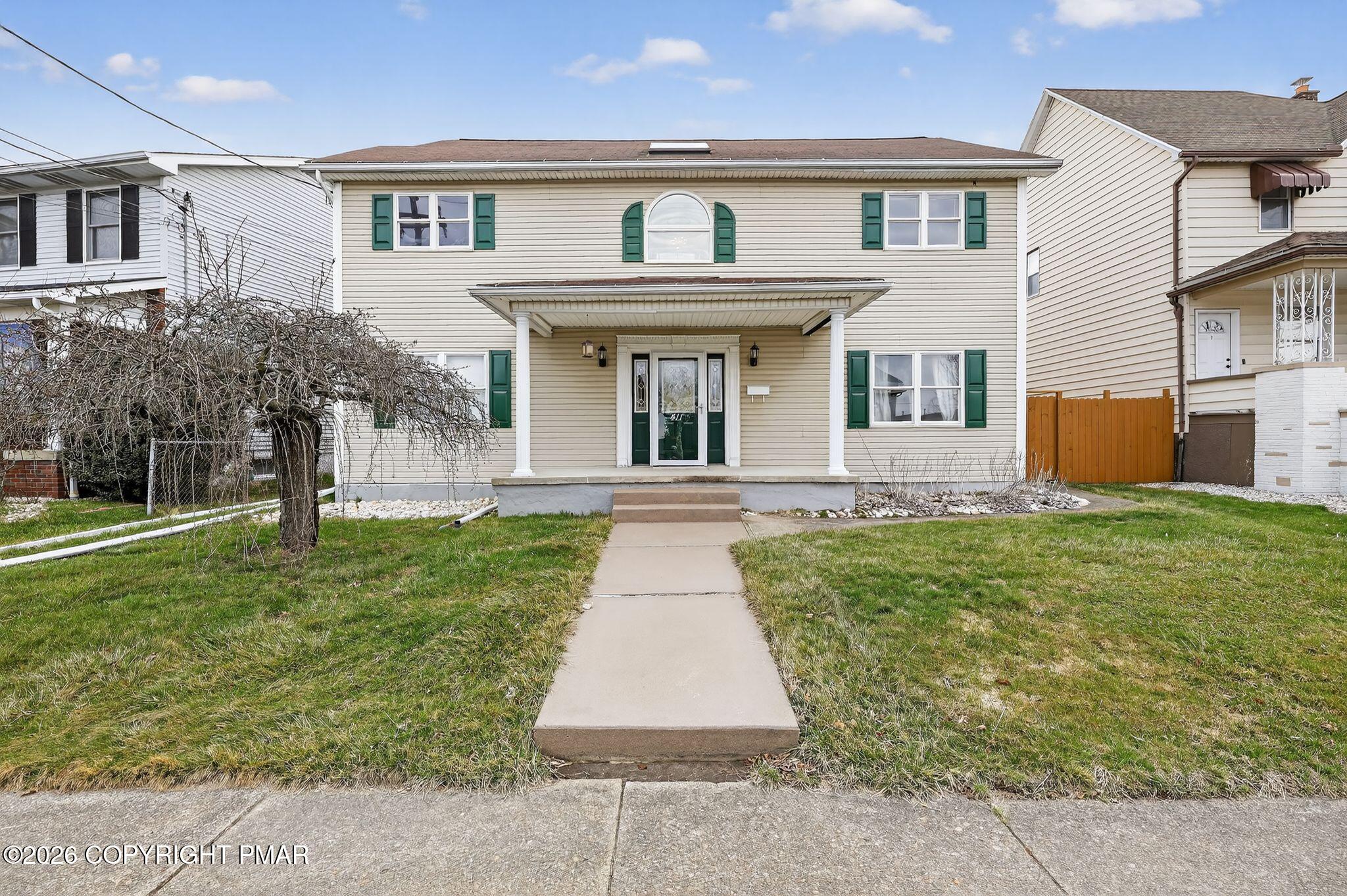 411 Moosic Road Old Forge, PA 18518 - Photo 1 of 59 a front view of a house with garden