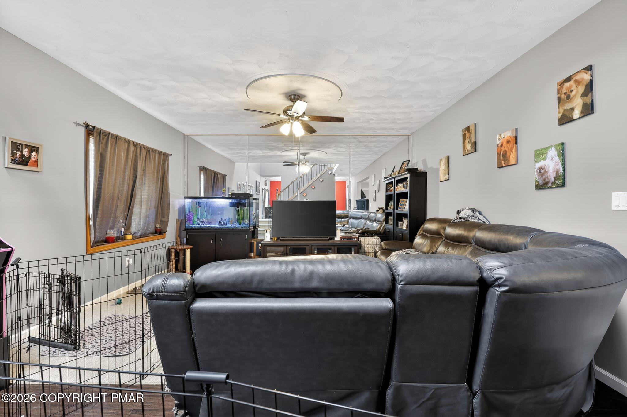 411 Moosic Road Old Forge, PA 18518 - Photo 19 of 59 a living room with furniture a fireplace and a flat screen tv