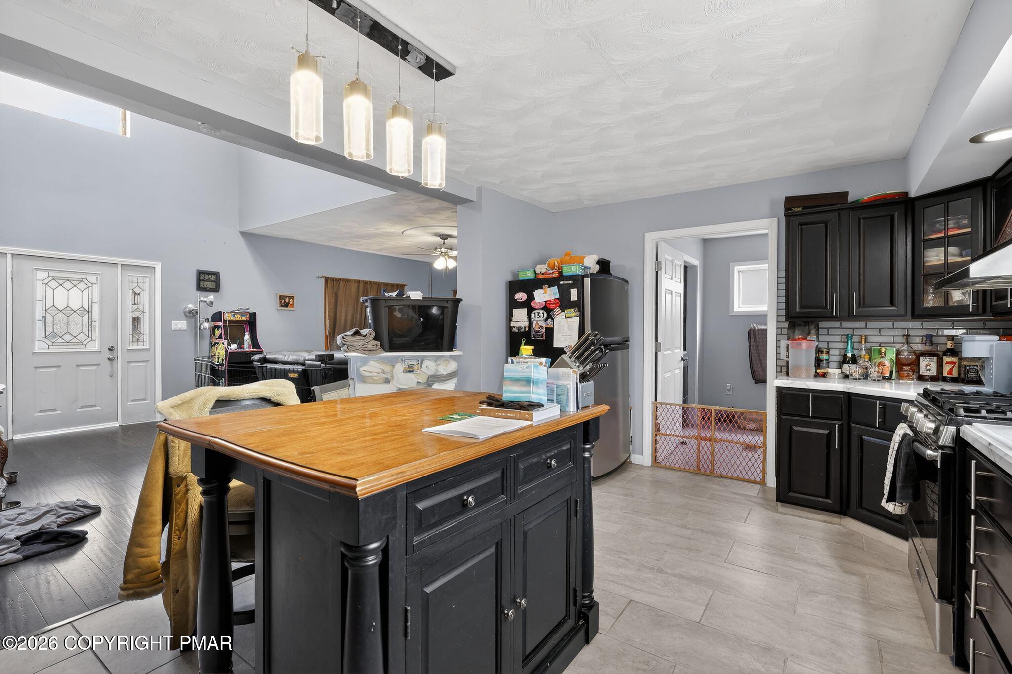 411 Moosic Road Old Forge, PA 18518 - Photo 22 of 59 a room with stainless steel appliances kitchen island granite countertop a refrigerator and a stove top oven