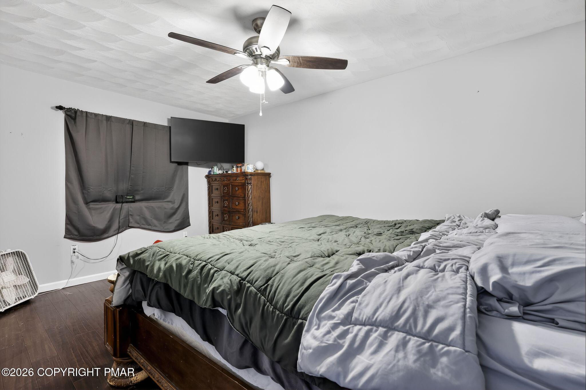 411 Moosic Road Old Forge, PA 18518 - Photo 26 of 59 a bedroom with a bed tv and a window