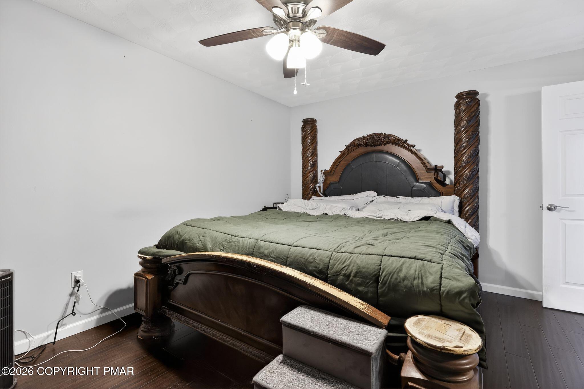 411 Moosic Road Old Forge, PA 18518 - Photo 34 of 59 a bedroom with a bed and a chandelier