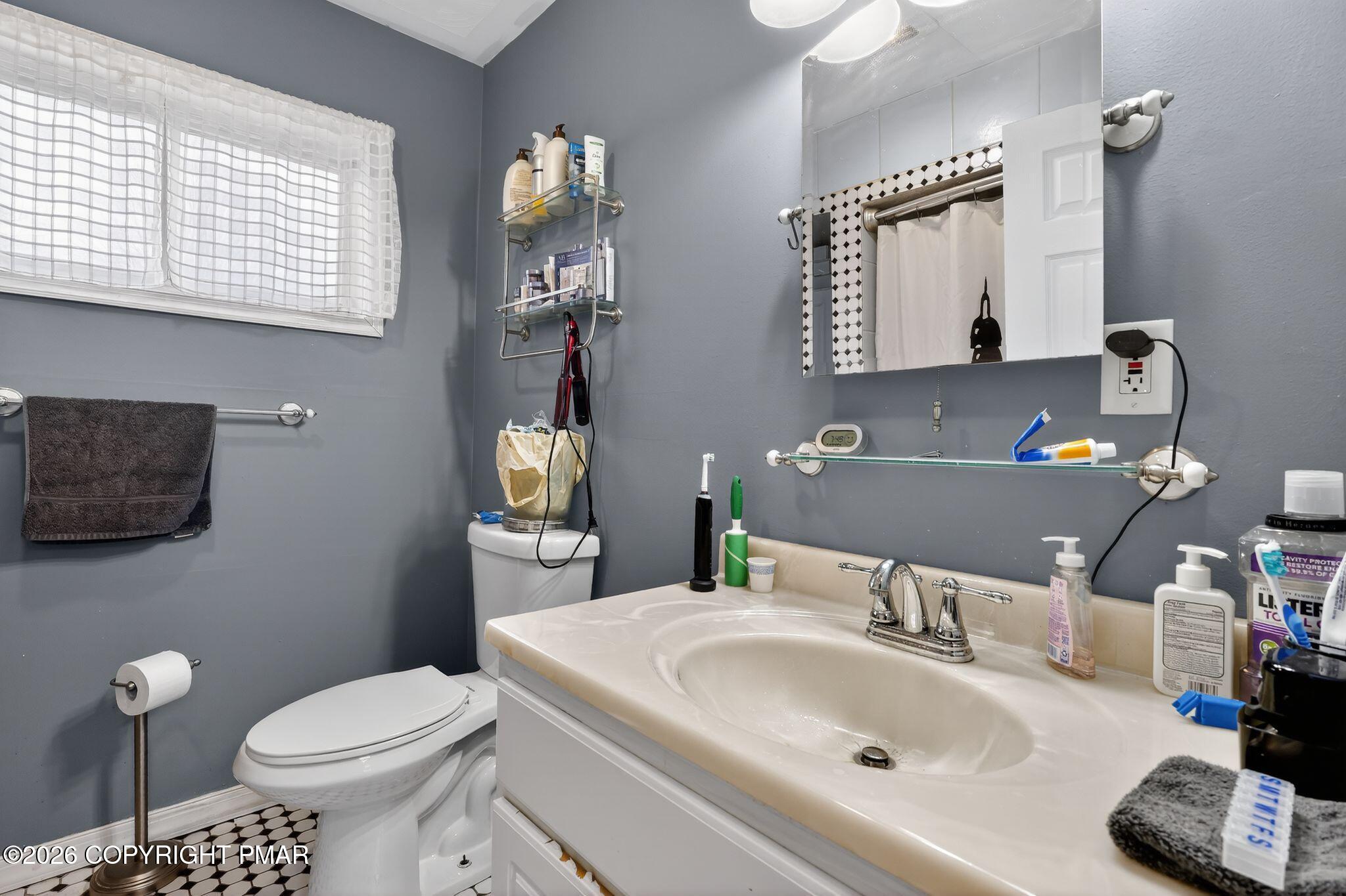 411 Moosic Road Old Forge, PA 18518 - Photo 39 of 59 a bathroom with a sink toilet and mirror