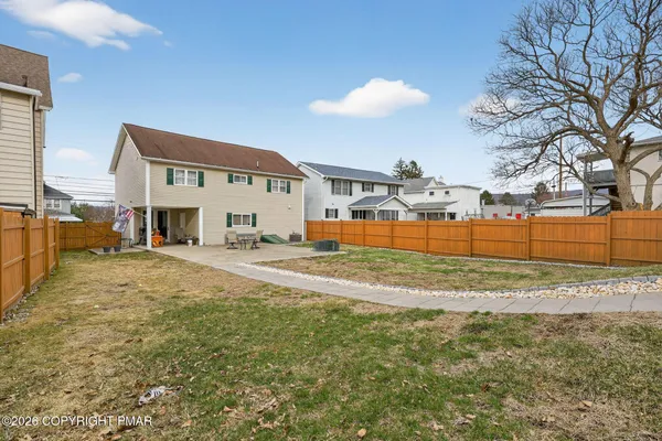 a view of a house with a yard and garage