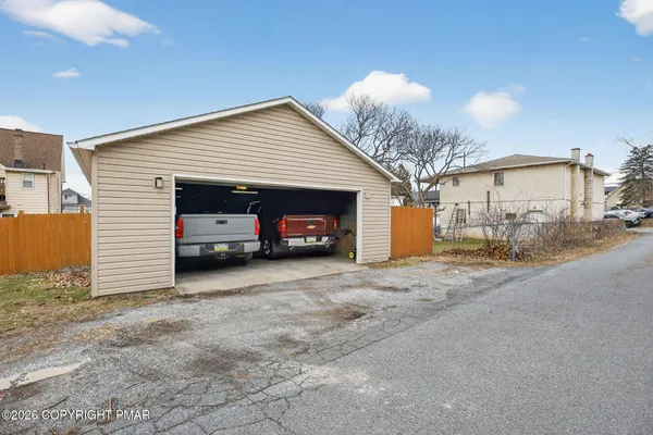 a view of a house with a yard and garage