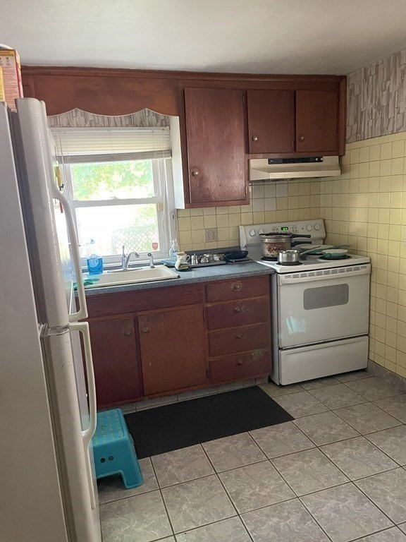25 Kirk Drive Springfield, MA 01109 - Photo 8 of 14 a kitchen with stainless steel appliances granite countertop a stove a sink and a refrigerator
