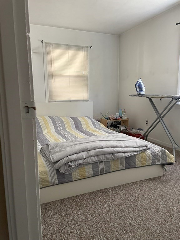 25 Kirk Drive Springfield, MA 01109 - Photo 9 of 14 a bedroom with a bed and window