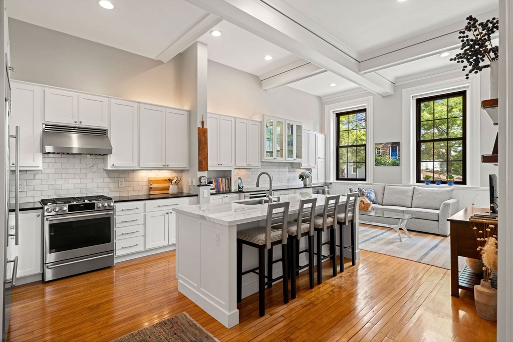 44 Pleasant Street, Unit 1 Marblehead, MA 01945 - Photo 2 of 35 a kitchen with stainless steel appliances granite countertop a stove and a wooden floors