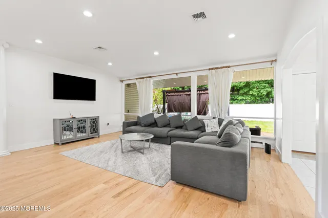 a living room with fireplace furniture and a flat screen tv