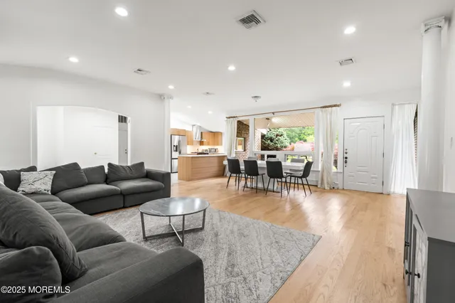 a living room with furniture and wooden floor