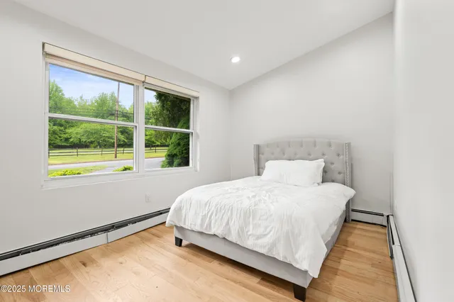 a view of a hallway with wooden floor and a window