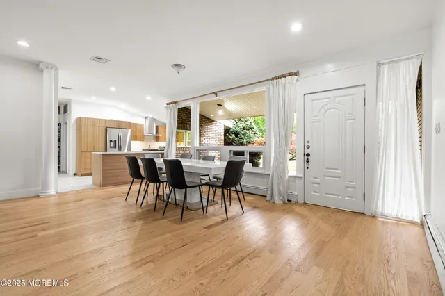a view of a dining room with furniture and wooden floor