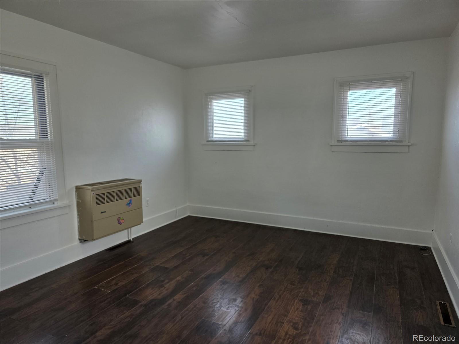 314 7th Street Ovid, CO 80744 - Photo 12 of 17 a view of an empty room with wooden floor and a window
