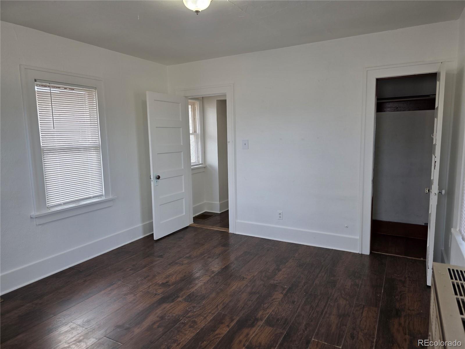 314 7th Street Ovid, CO 80744 - Photo 13 of 17 an empty room with wooden floor and window