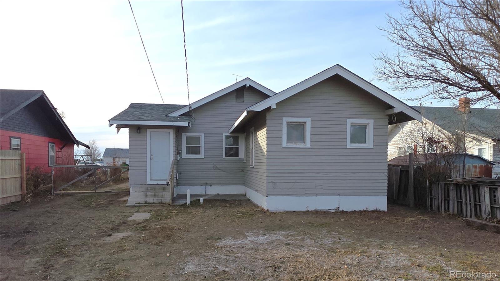 314 7th Street Ovid, CO 80744 - Photo 2 of 17 a view of a house with a yard and large tree