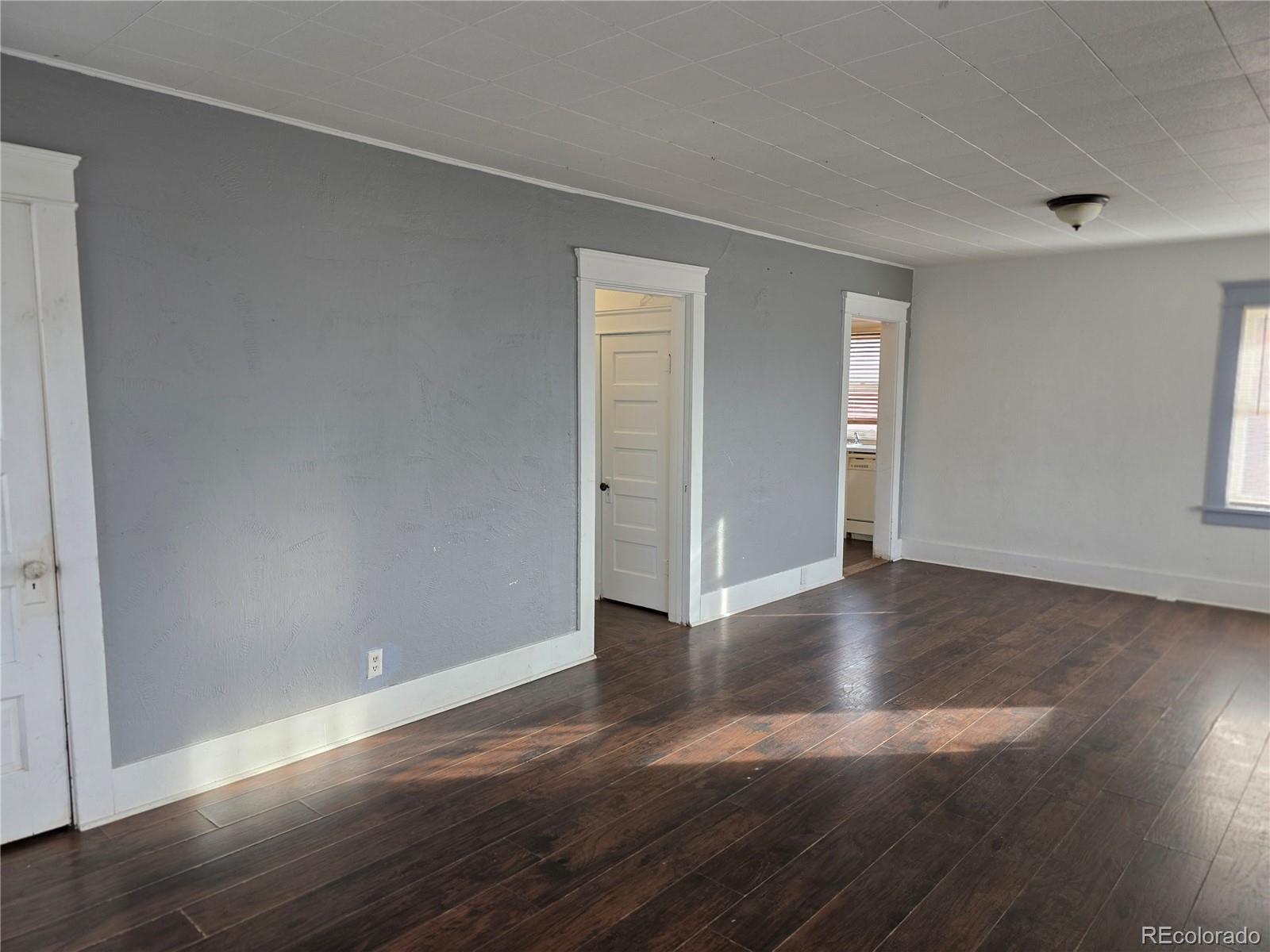 314 7th Street Ovid, CO 80744 - Photo 5 of 17 a view of an empty room with wooden floor and closet