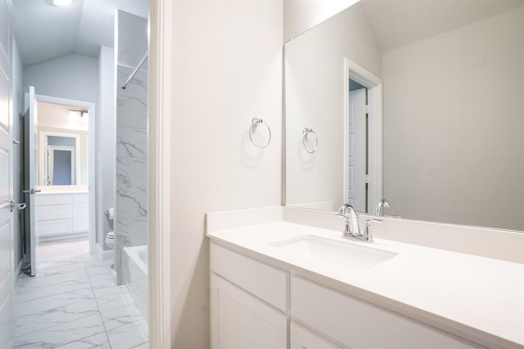 892 Panorama Drive Allen, TX 75013 - Photo 31 of 40 a bathroom with a sink and a mirror