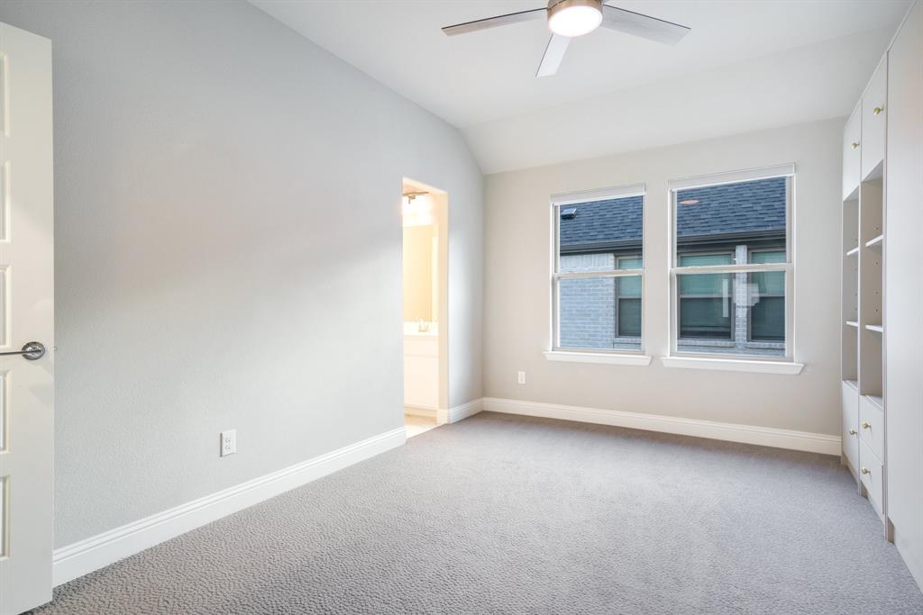 892 Panorama Drive Allen, TX 75013 - Photo 33 of 40 an empty room with a window and a chandelier fan