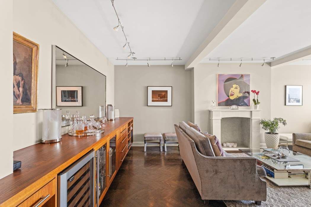 5 Riverside Drive, Unit 12B Manhattan, NY 10023 - Photo 4 of 21 a living room with furniture and a fireplace