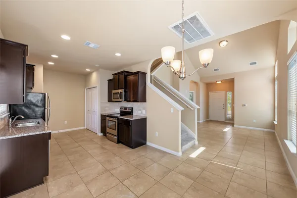 a view of kitchen with microwave and cabinets