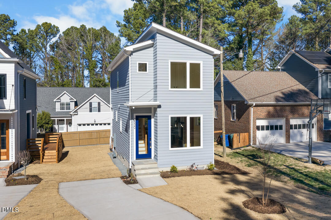 2530 West Wilson Street Durham, NC 27705 - Photo 39 of 49 a view of a white house with large windows next to a road