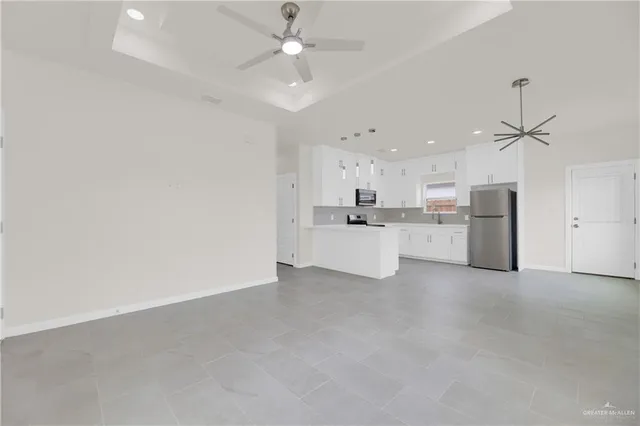 a view of a kitchen with a sink and a refrigerator