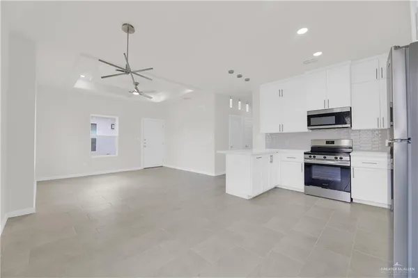 a kitchen with stainless steel appliances a refrigerator sink and stove top oven