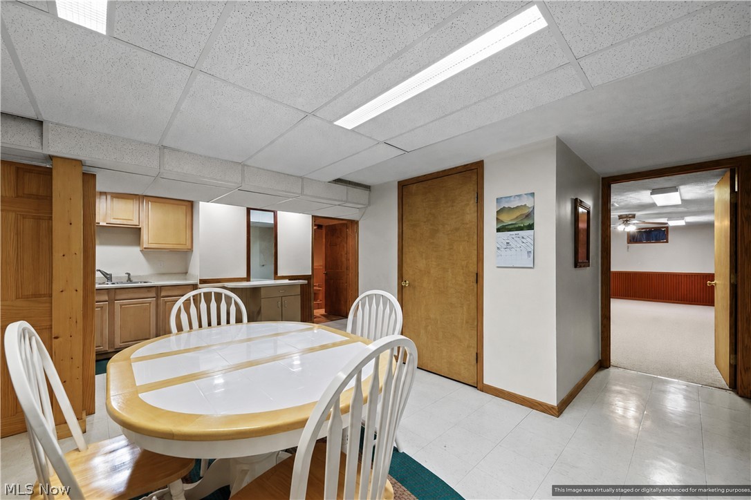1835 Lynn Road Kent, OH 44240 - Photo 26 of 48 Finished lower level featuring a compact kitchen area with a sink and cabinetry, wood-finish interior doors, recessed lighting, and white flooring